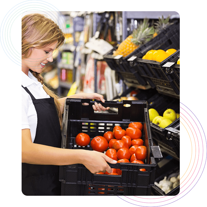 Restaurant staff holding a basket of tomatoes in inventory section 