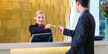 Hotel staff handing over a card to customer